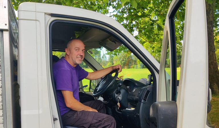 Park gardener sitting in van cab